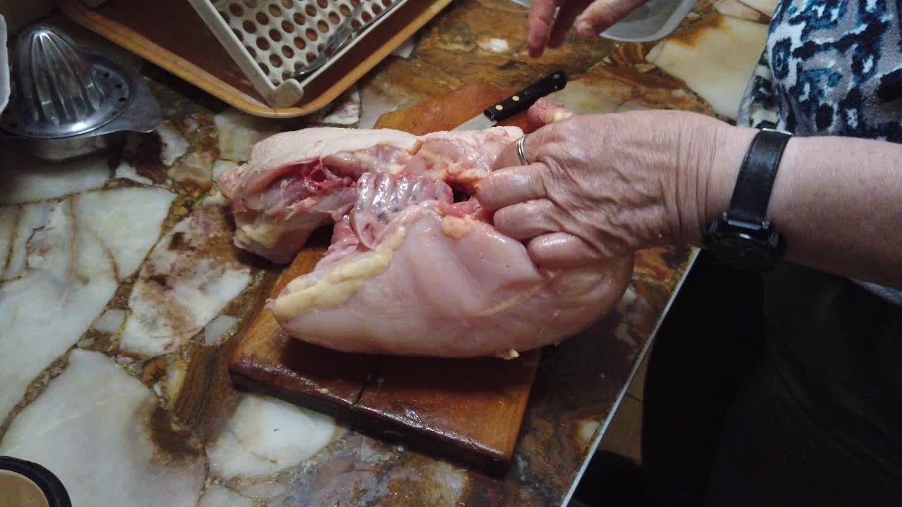 Organic Chicken Preparation CloseUp Elderly Hands Peel Raw Poultry, Home Kitchen