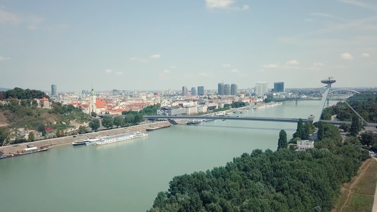 Backwards drone shot of a bridge over Danube river in Bratislava, Slovakia