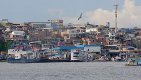 Manaus-Favela,-Amazonia-Brazil-Humble-Slum-Houses-and-Boats,-River-Panning-View