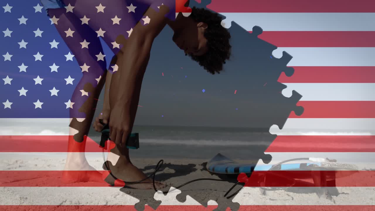 animación de la bandera estadounidense ondeando con rompecabezas que revelan a un hombre de raza mixta en la playa