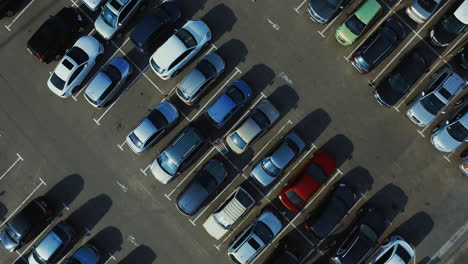 aerial view people walking at parking. drone footage man moving trolley