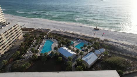 outdoor pools of beachfront hotel with scenic view of white-sand beach and sea at summer in panama city beach, florida, usa. - aerial