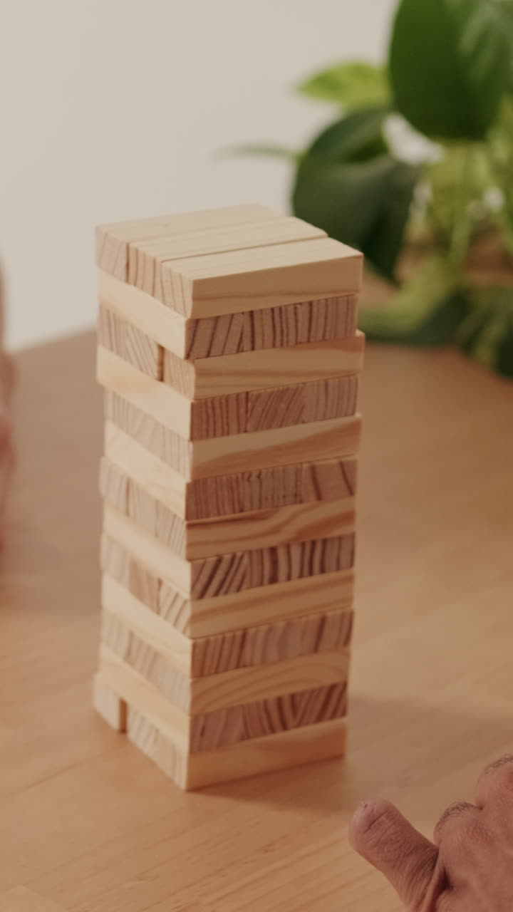 Couple Plays Jenga at Home