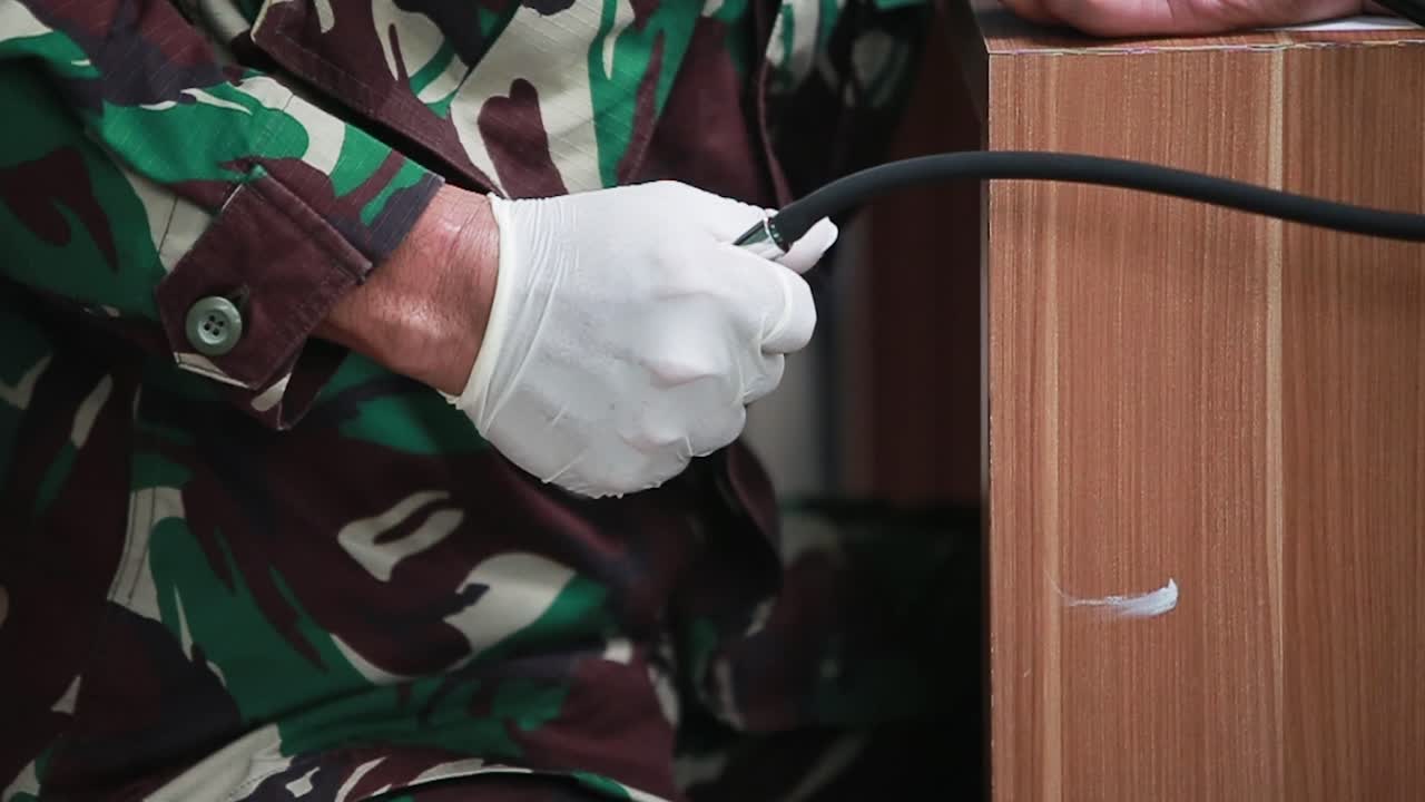 Army Doctor Taking Blood Pressure of a Patient