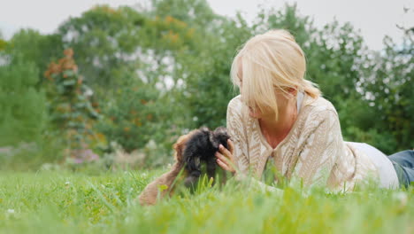 woman playing with puppies