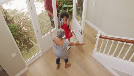 Grandmother-embracing-her-grandchildren-at-home