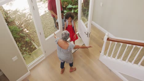 grandmother embracing her grandchildren at home