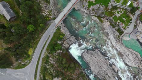 Aerial-along-the-river-and-road-near-Donnfossen,-Nordberg,-Norway