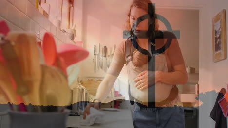 carrying baby in sling, woman cleaning kitchen counter in animation scene