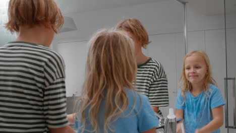 siblings washing their faces together in the morning