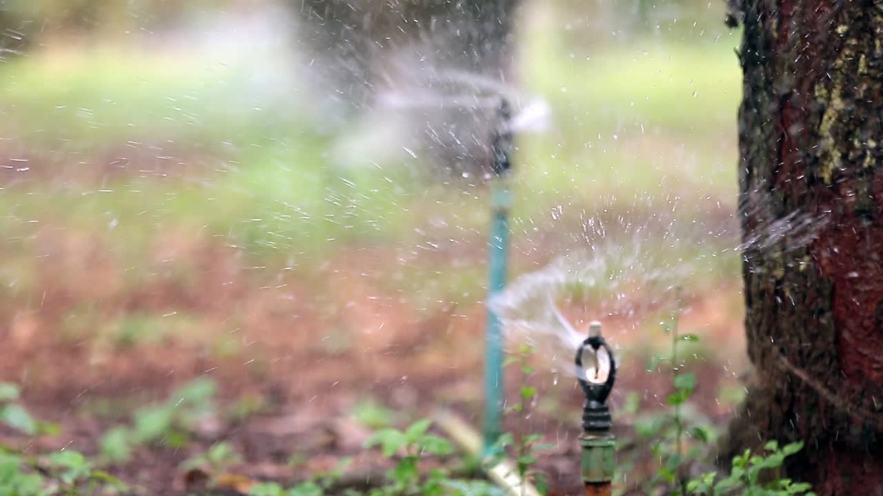 Close Up Footage of Water Sprinkler Splash The Water On The Field