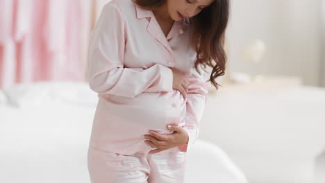 pregnant woman in pink pajamas