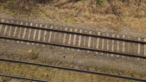 Unusual-aerial-top-down-rising-over-railroad-tracks