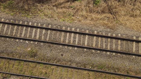 unusual aerial top-down rising over railroad tracks