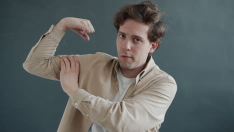 man in a beige shirt gesturing