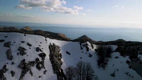 man hiking peak of mountain against the adriatic sea, biokovo, croatia