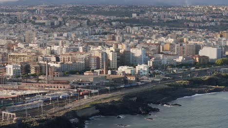 cargo train passing on the sea side at the city of catania in italia