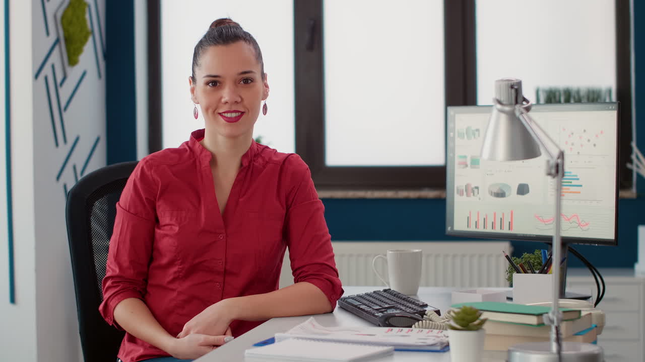 Portrait of female employee using computer to do research