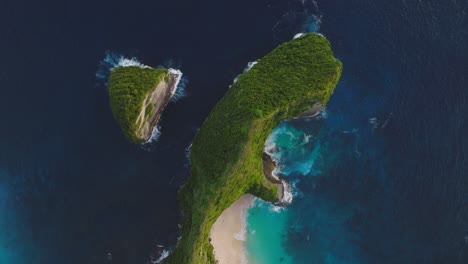 Vibrant-tropical-colors-at-famous-tourist-destination-Kelingking-beach,-T-Rex-shape-rock-formation,aerial