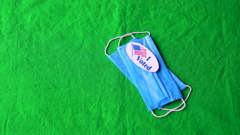 rackfocus blue surgical masks with i voted stickers on green screen