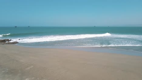 Surfers-waiting-for-big-sea-wave-near-Lobitos,-Peru