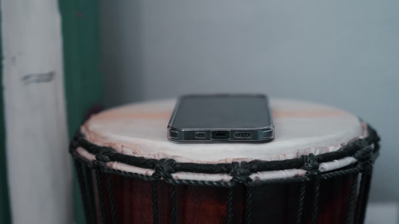 Man hand grabbing smartphone on table nightstand next to bed, reaching to mobile phone in morning evening living in social digital world.