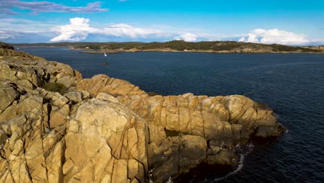 Beautiful-Norwegian-summer-coastline-dark-blue-sky-with-clouds-in-the-background