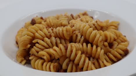 Fusilli-pasta-with-ragù-bolognese,-bolognese-sauce,-isolated-on-white-background