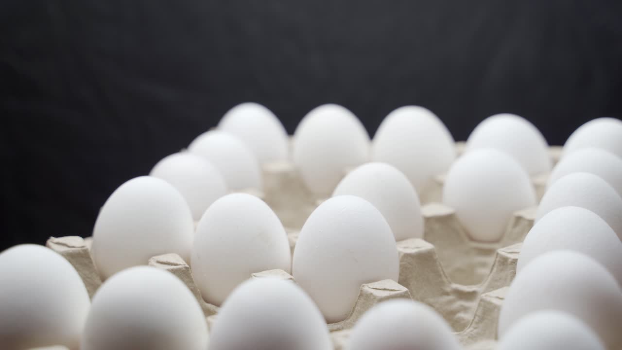 Eggs are stacked in a tray. Crates of fresh eggs at a poultry farm.