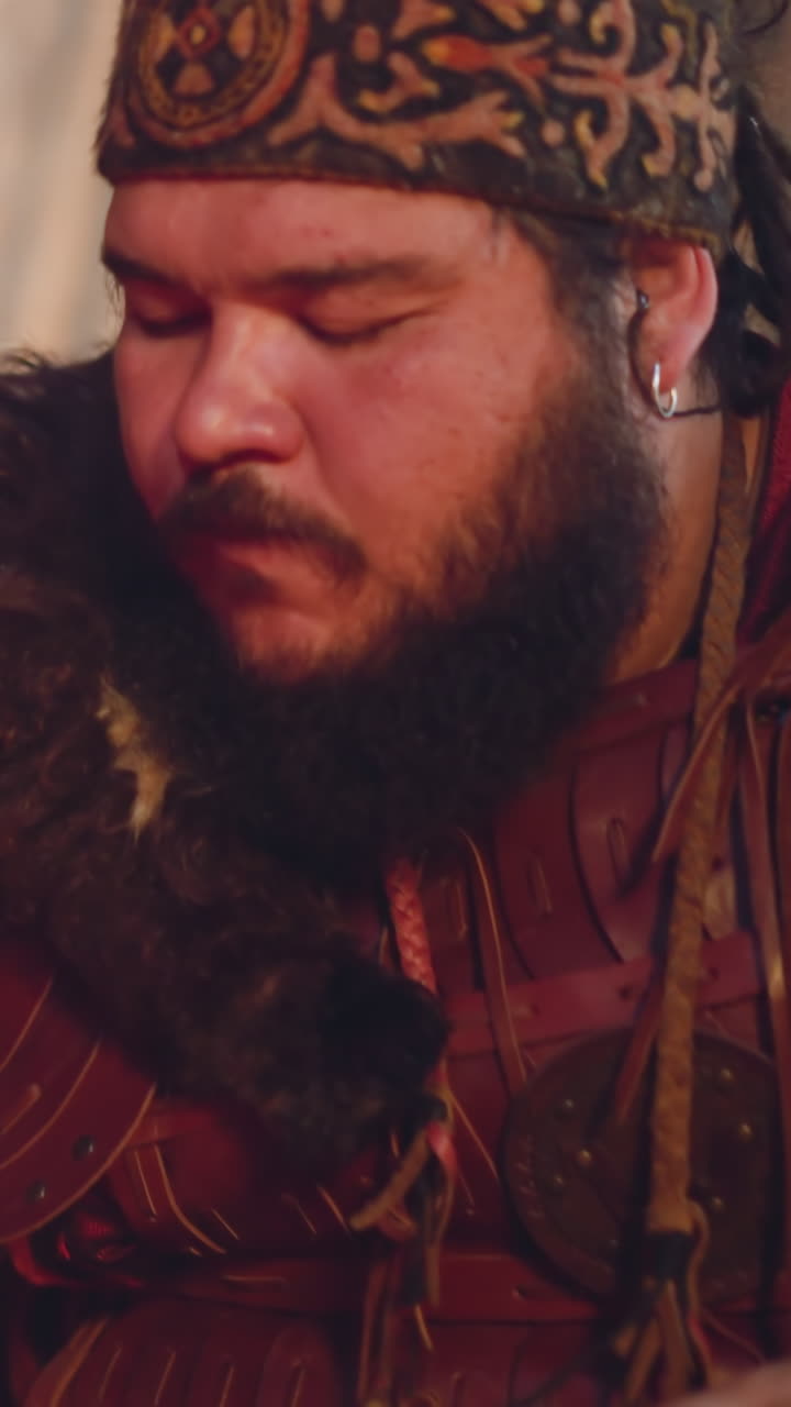 Concentrated musician in traditional folk clothes plays Altai harp in cabin closeup slow motion. Old ethnic music traditions at contemporary stadium