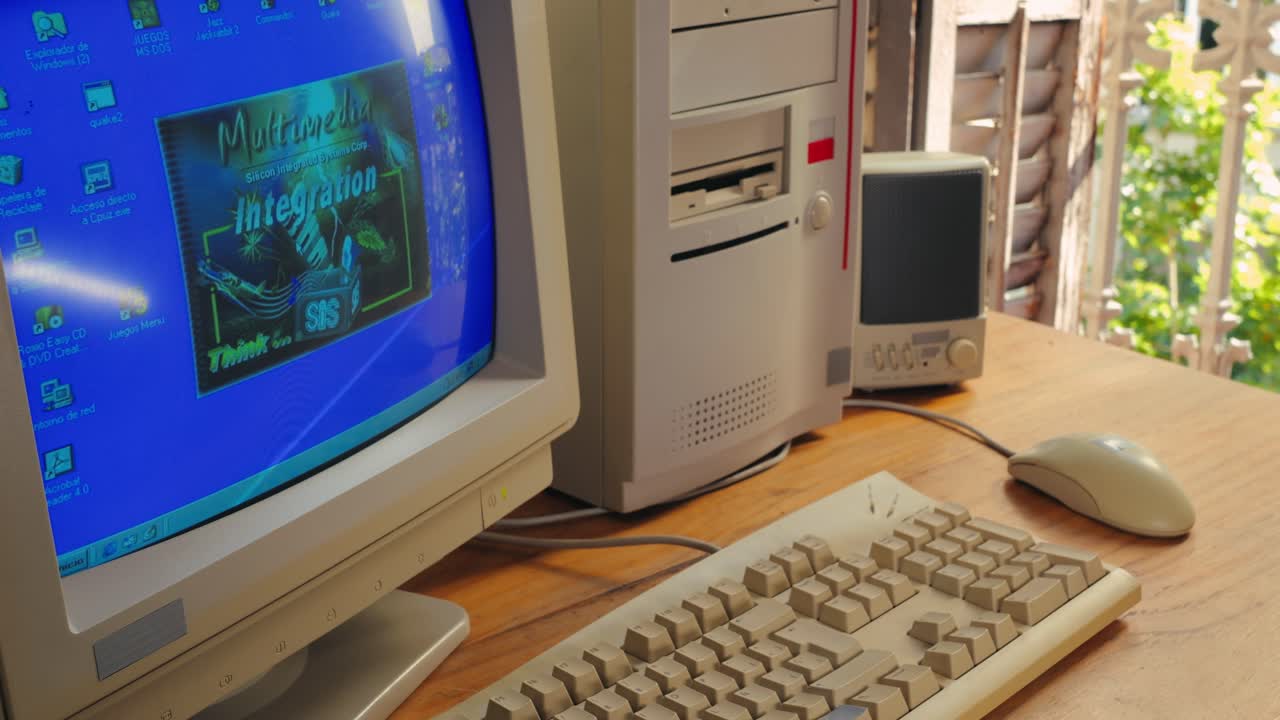 BARCELONA, SPAIN, 10 JUNE 2025. Man working and gaming on retro computer PC, IT engineer with vintage computer at home, using old fashion technology, close up of retro setup.