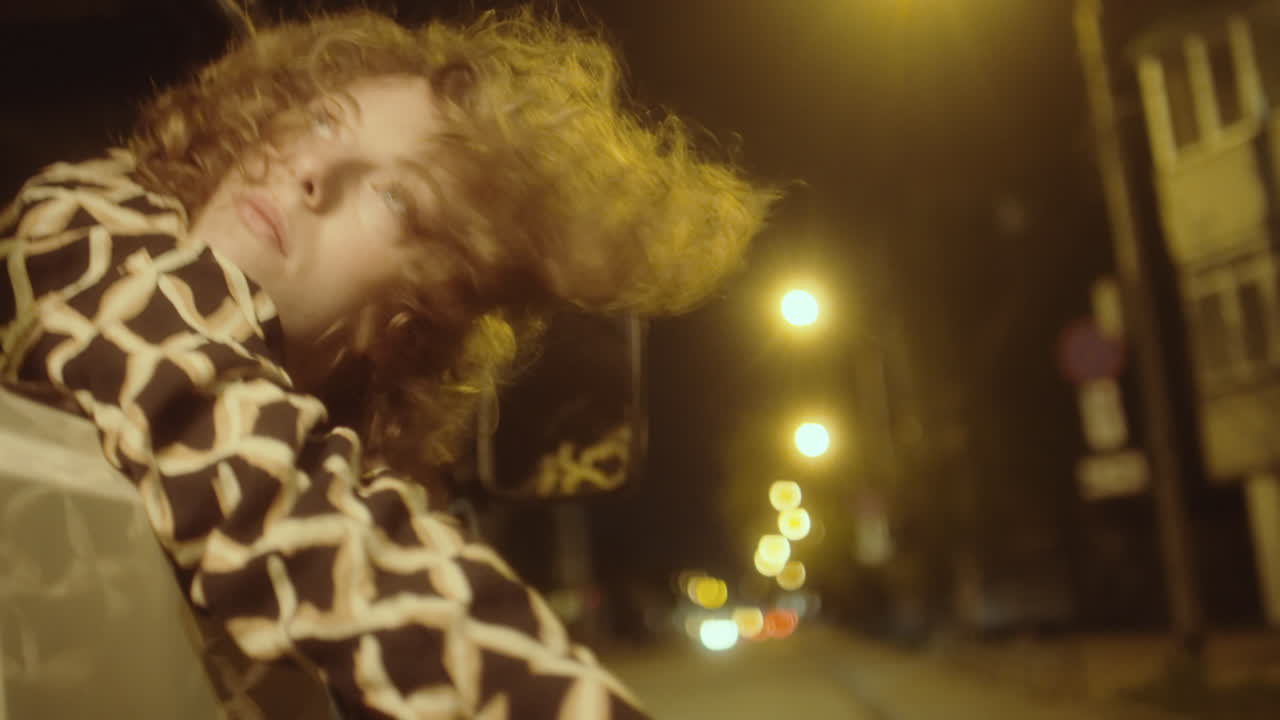 Woman Looking Out Car Window during Night Road Trip