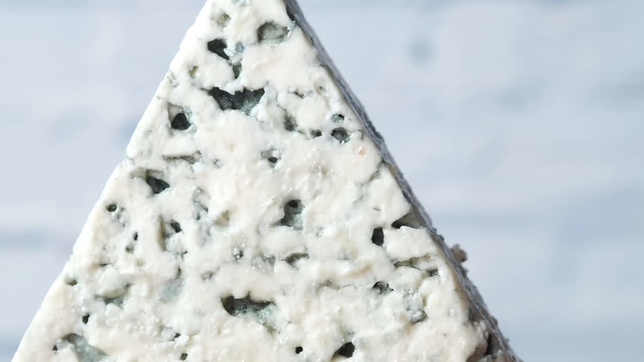 Close-up of a triangular wedge of blue cheese
