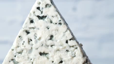 close-up of a triangular wedge of blue cheese