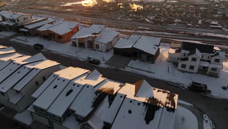 AERIAL---Snowy-winter-sunrise-in-Ridge-North,-North-Salt-Lake,-Utah,-forward-tilt-up