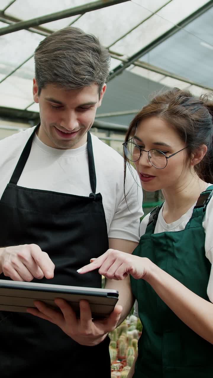 Employees collaborating in a greenhouse
