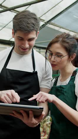 employees collaborating in a greenhouse