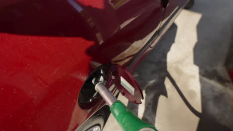 point of view shot of a person filling up a fuel tank at a petrol station