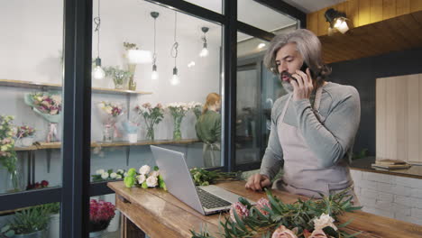 florist talking to customer via smartphone