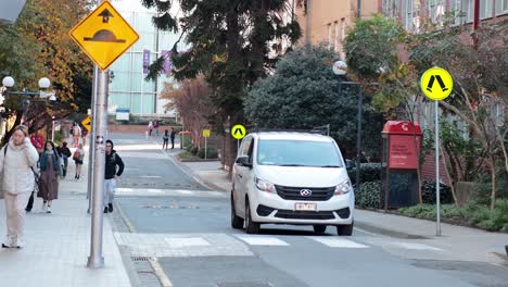 people crossing street near parked van