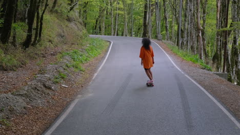 girl skateboarding on a mountain road