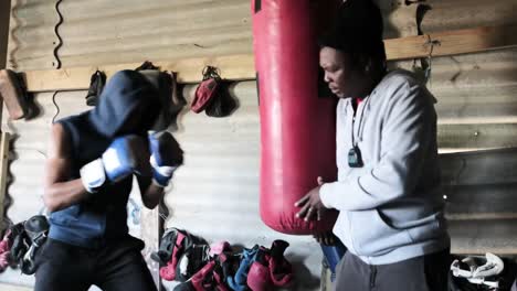 boxer punching a punching bag in the gym