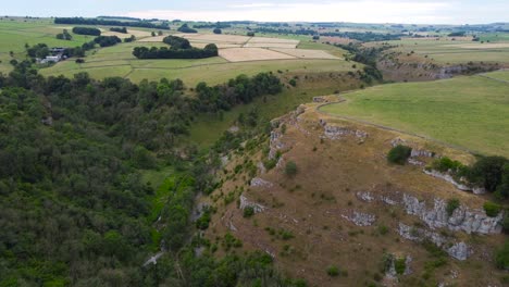 Aerial-view-over-Peak-district-woodland-valley-idyllic-rural-rolling-countryside