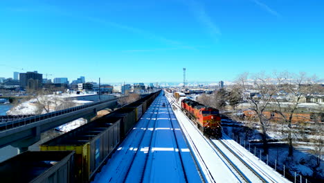 Close-up-of-railroad-tracks-with-freight-train-stopped-on-the-siding