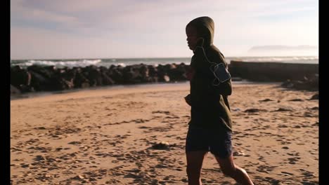 african american male runner jogging on the beach 4k