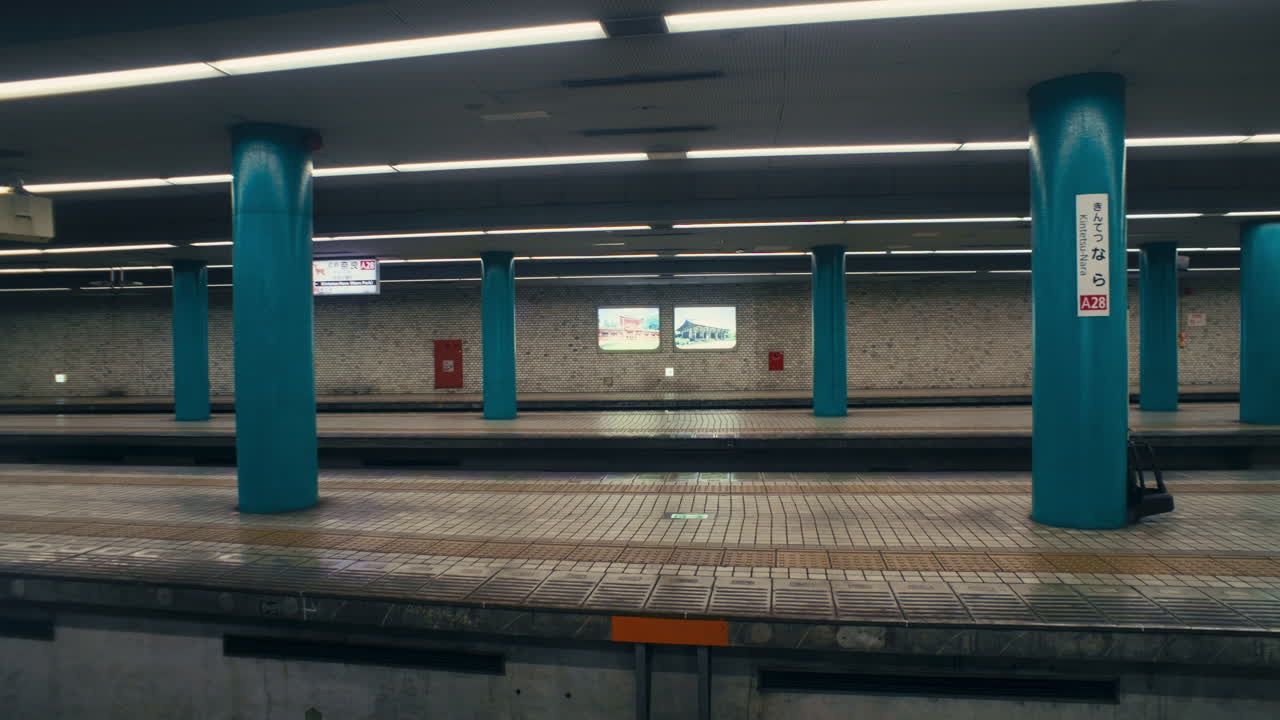 Japan metro scene showing tiled station floor and arriving yellow train