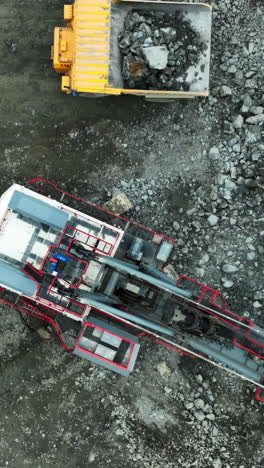 aerial view of heavy machinery and dump truck at a quarry