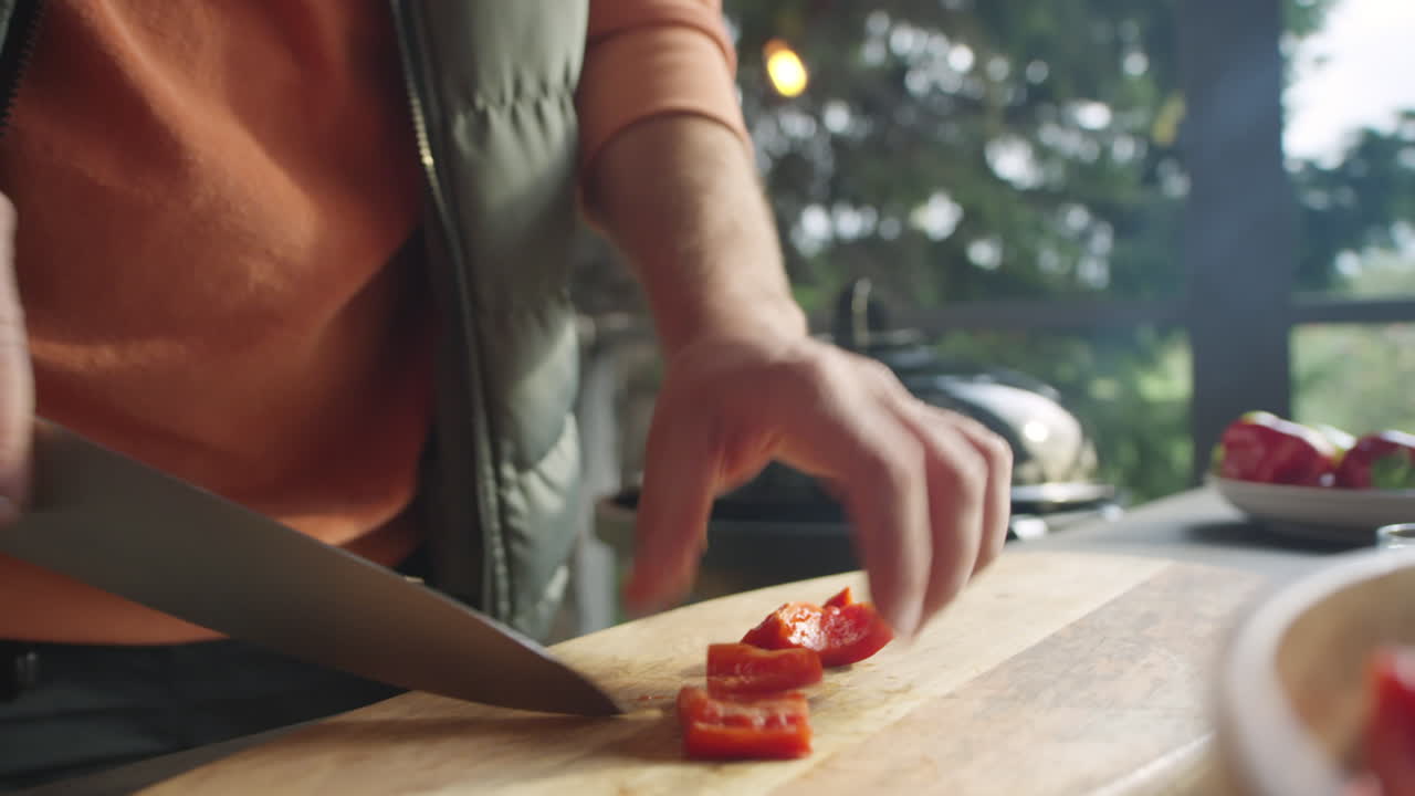 Hands of Chef Cutting Red Bell Pepper