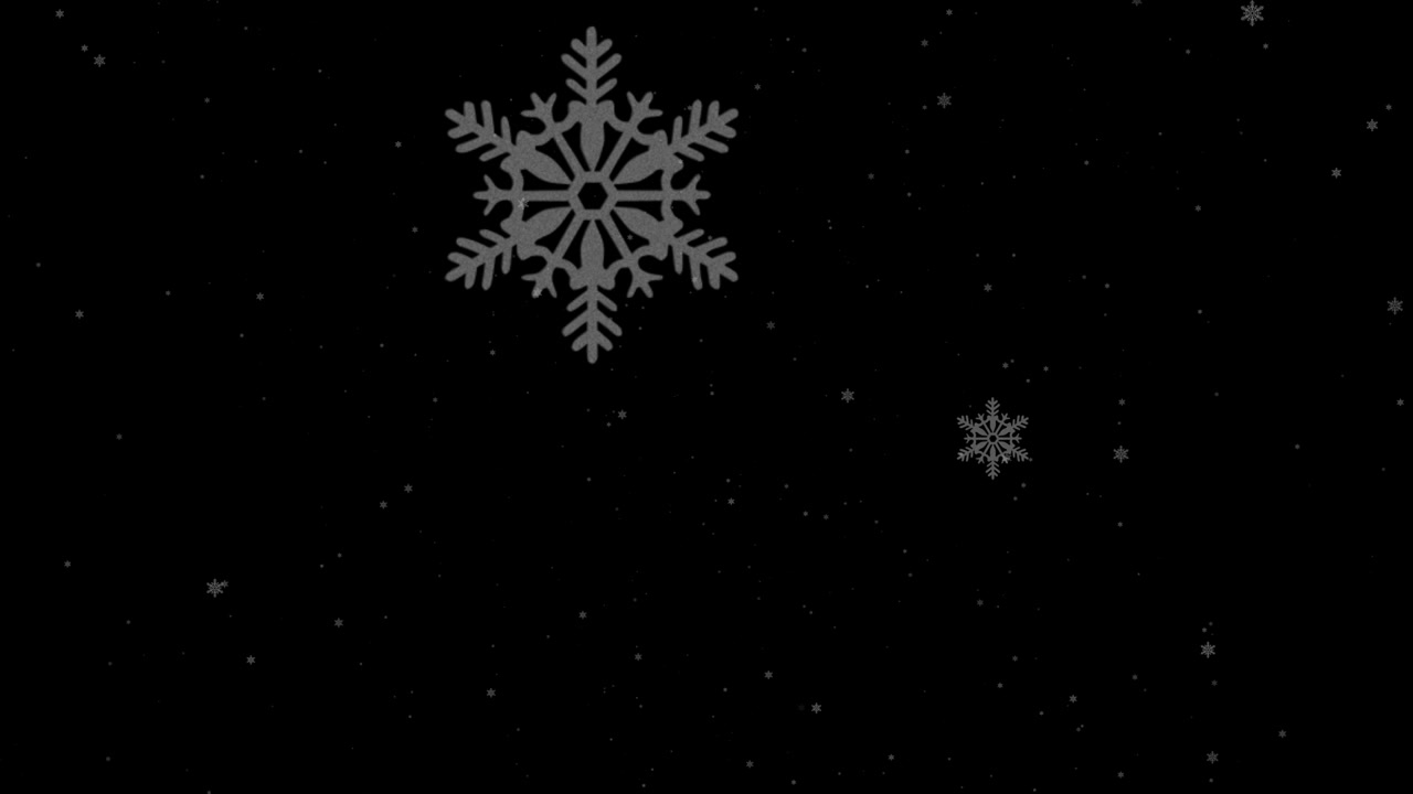 Fallende snøflak på svart bakgrunn
