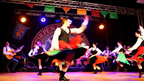 energetic folk dance performance with live music on stage